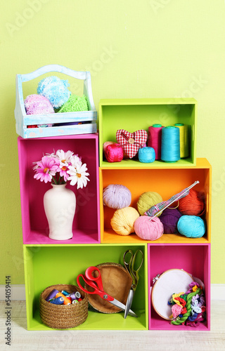 Photo: Colorful shelves of different colors with utensils Colorful shelves of different colors with utensils
