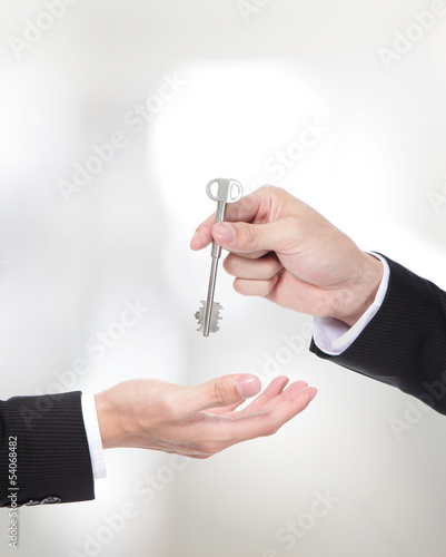 Photo: Male hand holding apartment keys Male hand holding apartment keys
