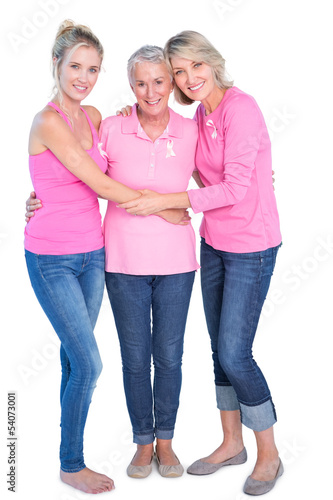 Photo: Cheerful women wearing pink tops and ribbons for breast cancer Cheerful women wearing pink tops and ribbons for breast cancer