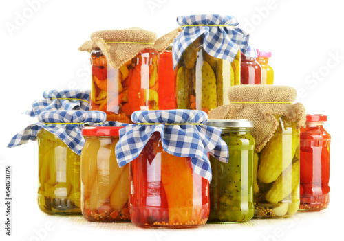 Photo: Composition with jars of pickled vegetables. Marinated food Composition with jars of pickled vegetables. Marinated food