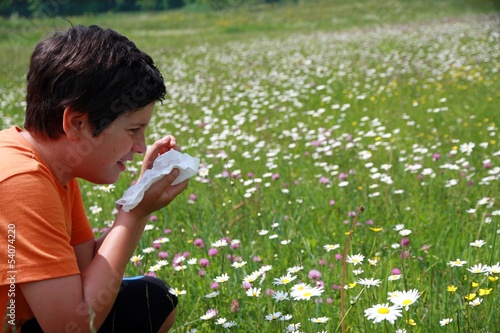 Photo: allergic child to pollen and flowers with a handkerchief while s allergic child to pollen and flowers with a handkerchief while s