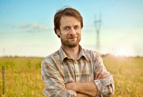 Photo: Happy farmer standing in front of his fields Happy farmer standing in front of his fields