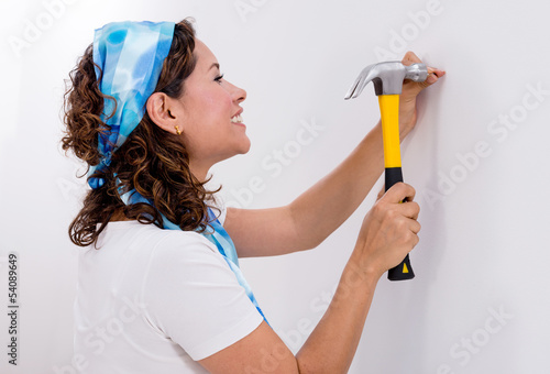 Photo: Woman hitting a nail Woman hitting a nail