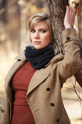 Photo: Sad beautiful woman in autumn forest Sad beautiful woman in autumn forest