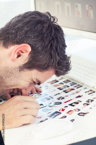 Photo: Photo editor using a magnifying loupe Photo editor using a magnifying loupe