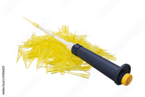 Photo: Automatic lab pipet on disposable tips heap Automatic lab pipet on disposable tips heap