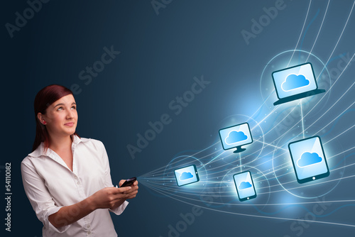 Photo: Pretty lady typing on smartphone with cloud computing Pretty lady typing on smartphone with cloud computing