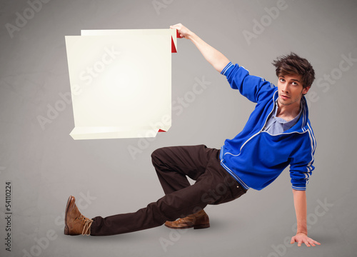Photo: Young man holding white origami paper copy space Young man holding white origami paper copy space