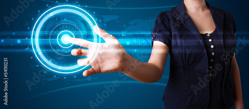 Photo: Woman pressing high tech type of modern buttons Woman pressing high tech type of modern buttons