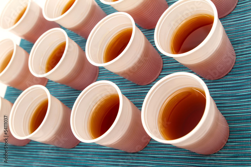 Photo: Disposable cups with tea. Disposable cups with tea.