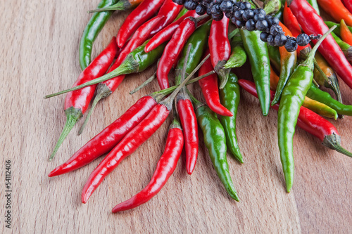 Photo: Red hot chili peppers on wooden background Red hot chili peppers on wooden background