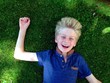 boy lying on grass boy lying on grass