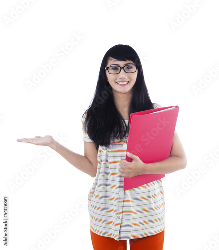 Photo: Asian college student showing something on copyspace Asian college student showing something on copyspace