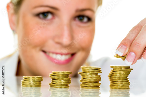 Photo: Frau mit Münzstapel beim Geld sparen Frau mit Münzstapel beim Geld sparen