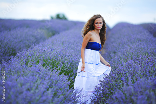 Photo: Woman standing on a lavender field Woman standing on a lavender field