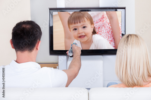 Photo: Portrait of couple watching television Portrait of couple watching television