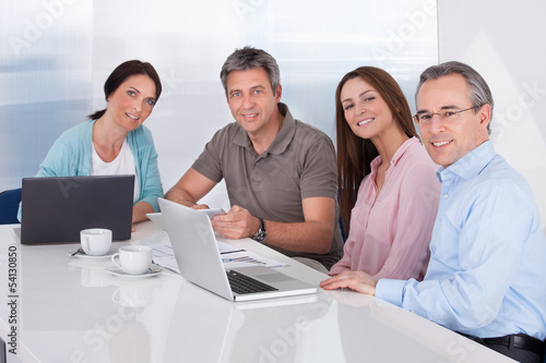 Photo: Portrait Of Businesspeople Working Portrait Of Businesspeople Working