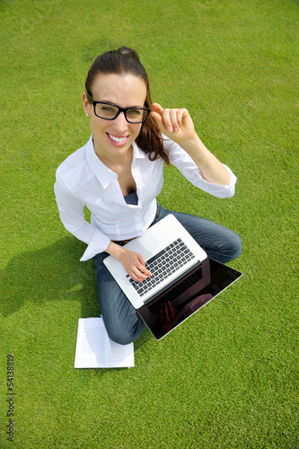 Photo: woman with laptop in park woman with laptop in park