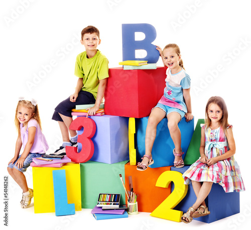 Photo: Children sitting at cube. Children sitting at cube.