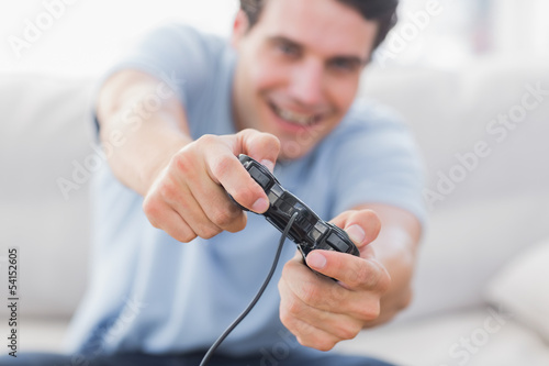 Photo: Portrait of a smiling man playing video games Portrait of a smiling man playing video games