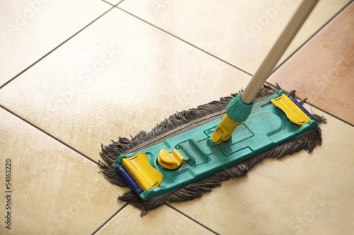 Photo: cleaning the floor with a mop cleaning the floor with a mop
