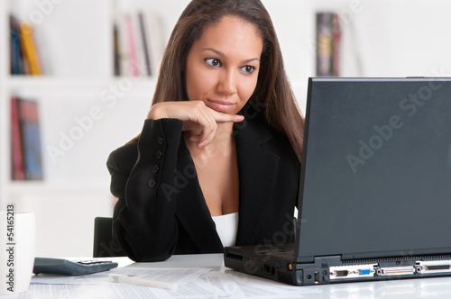 Photo: Businesswoman At Office Desk Businesswoman At Office Desk