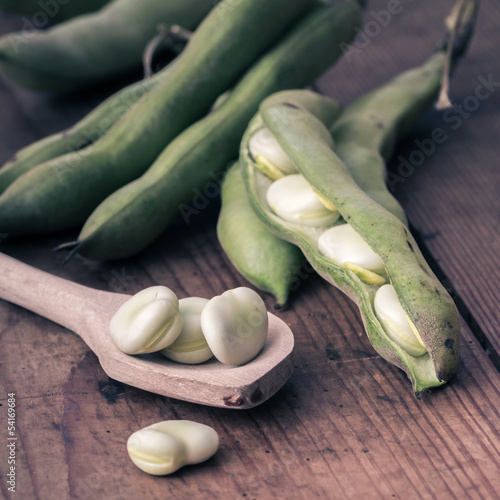 Photo: Broad Beans on a wooden Table with Spoon Broad Beans on a wooden Table with Spoon