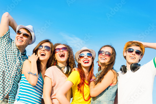 Photo: group of young people wearing sunglasses and hat group of young people wearing sunglasses and hat
