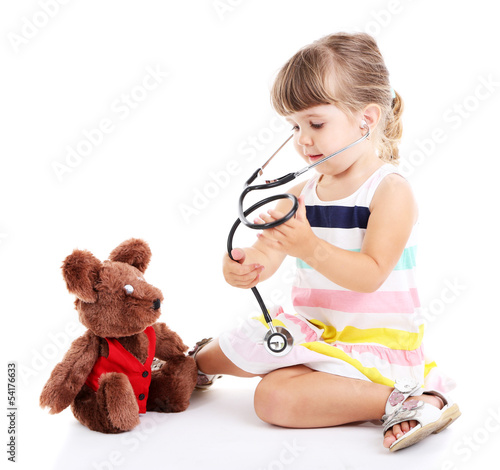 Photo: Little cute girl playing doctor, isolated on white Little cute girl playing doctor, isolated on white