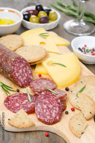 Photo: salami, cheese and crackers on a cutting board salami, cheese and crackers on a cutting board