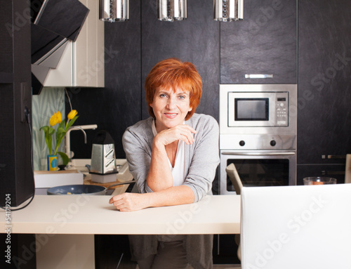 Photo: Woman at kitchen Woman at kitchen