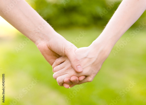 Photo: Close up of couple holding hands Close up of couple holding hands