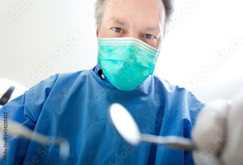 Photo: Dentist doing a treatment Dentist doing a treatment