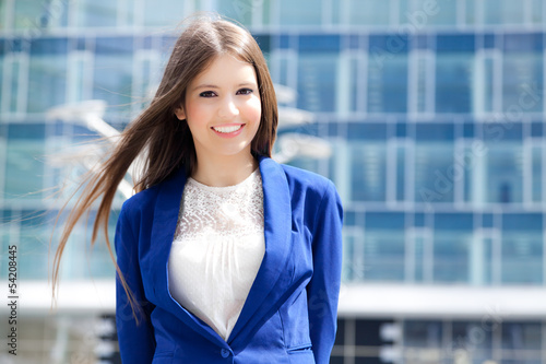 Photo: Smiling young businesswoman outdoor Smiling young businesswoman outdoor