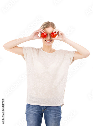 Photo: Beaitiful woman with tomatos in front of the face Beaitiful woman with tomatos in front of the face