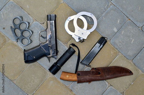 Photo: pistol, brass knuckles, handcuffs and a knife pistol, brass knuckles, handcuffs and a knife