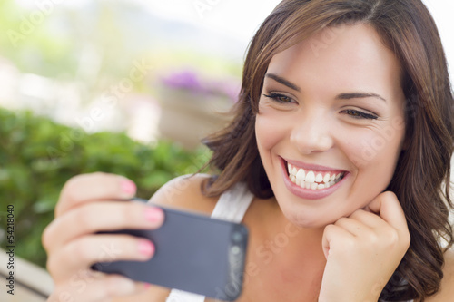 Photo: Pretty Adult Female Texting on Cell Phone Outdoors Pretty Adult Female Texting on Cell Phone Outdoors
