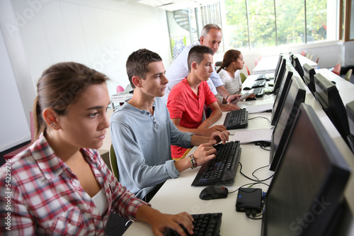Photo: Group of young people in computing class Group of young people in computing class