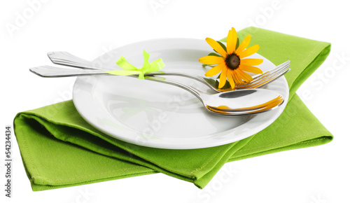 Photo: spoon, fork and flower on plate, isolated on white spoon, fork and flower on plate, isolated on white