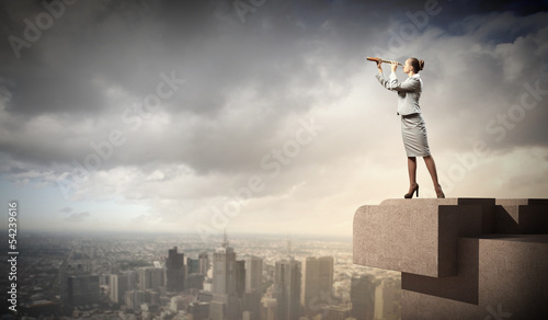 Photo: Business woman with telescope Business woman with telescope