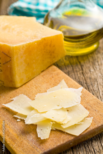 Photo: pieces of Italian hard cheese on a wooden table pieces of Italian hard cheese on a wooden table