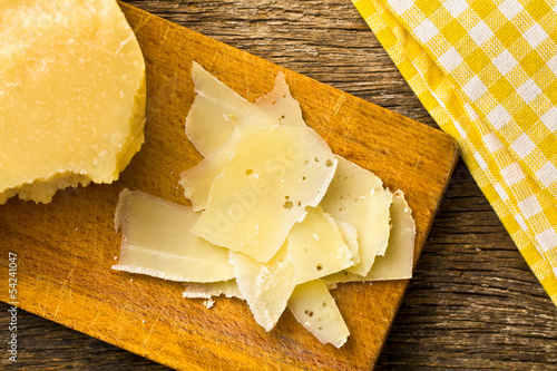Photo: pieces of Italian hard cheese on a wooden table pieces of Italian hard cheese on a wooden table