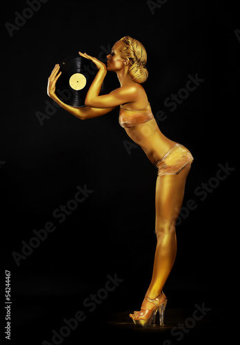 Photo: Futurism. Golden Woman DJ with Vinyl Record. Body Painting Futurism. Golden Woman DJ with Vinyl Record. Body Painting