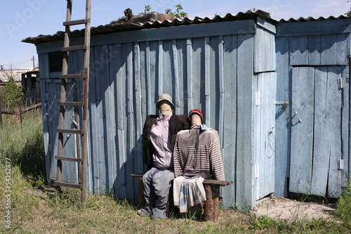 Photo: Two effigies near a shed Two effigies near a shed
