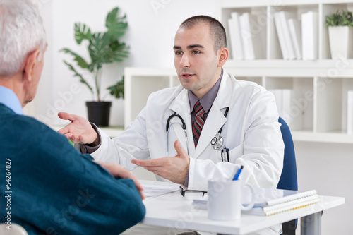 Photo: doctor explaining diagnosis to his patient doctor explaining diagnosis to his patient