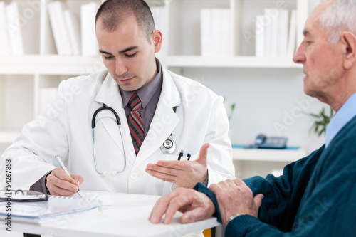 Photo: Doctor talking to senior patient Doctor talking to senior patient