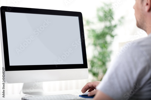 Photo: young man working on computer young man working on computer