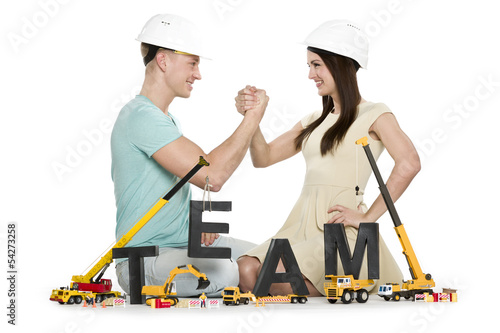 Photo: Forming a team: Joyful man and woman building team-word. Forming a team: Joyful man and woman building team-word.