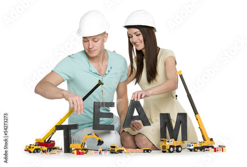 Photo: Forming a team: Joyous man and woman building team-word. Forming a team: Joyous man and woman building team-word.