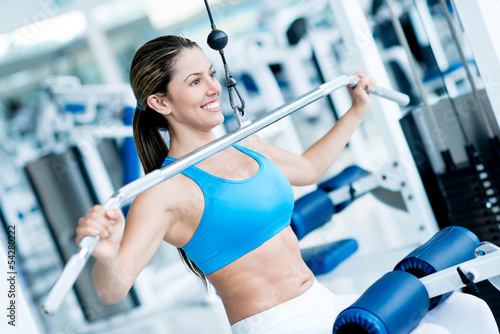 Photo: Woman exercising at the gym Woman exercising at the gym